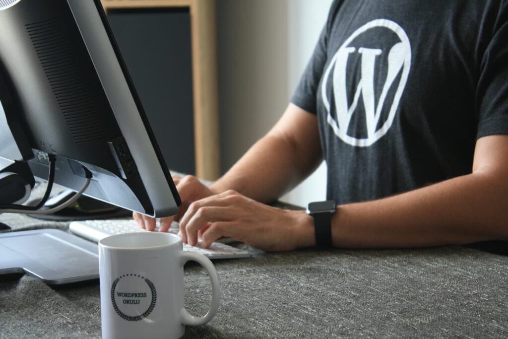 person on computer wearing WordPress Tshirt